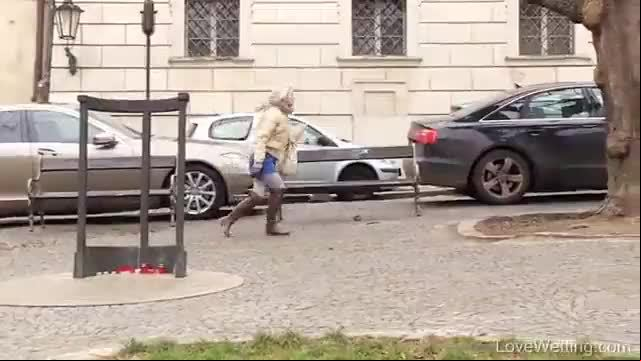 Young lady bursting to pee in public wets herself while talking in her mobile
